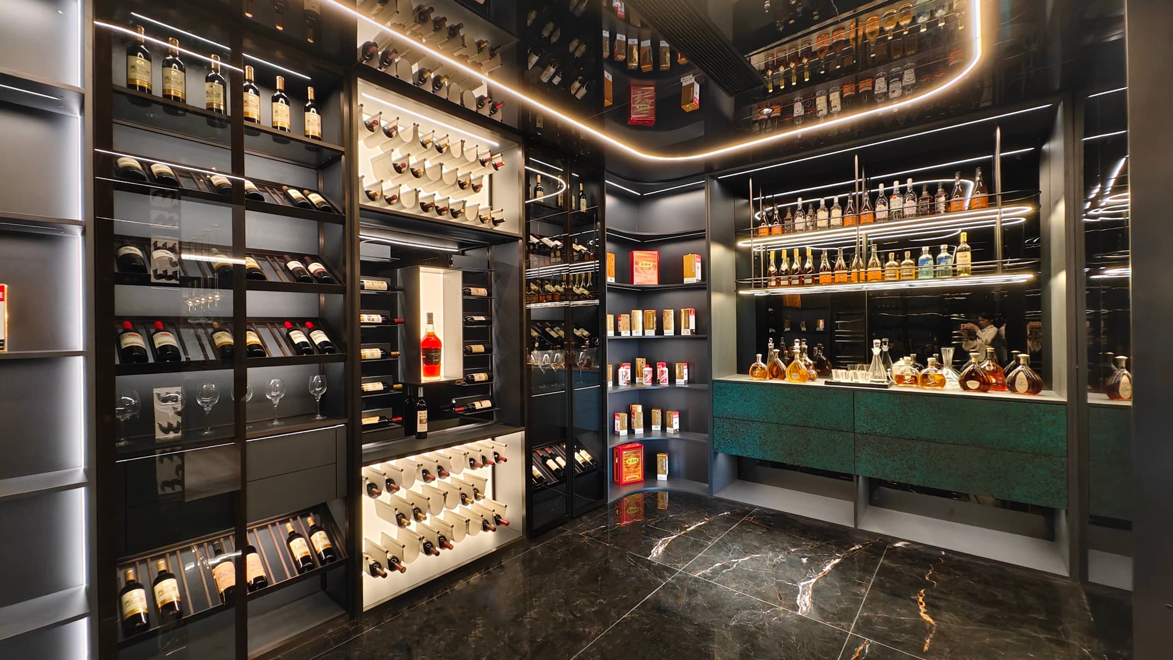 Cabinet detail with steel, stone, and warm wall tones.