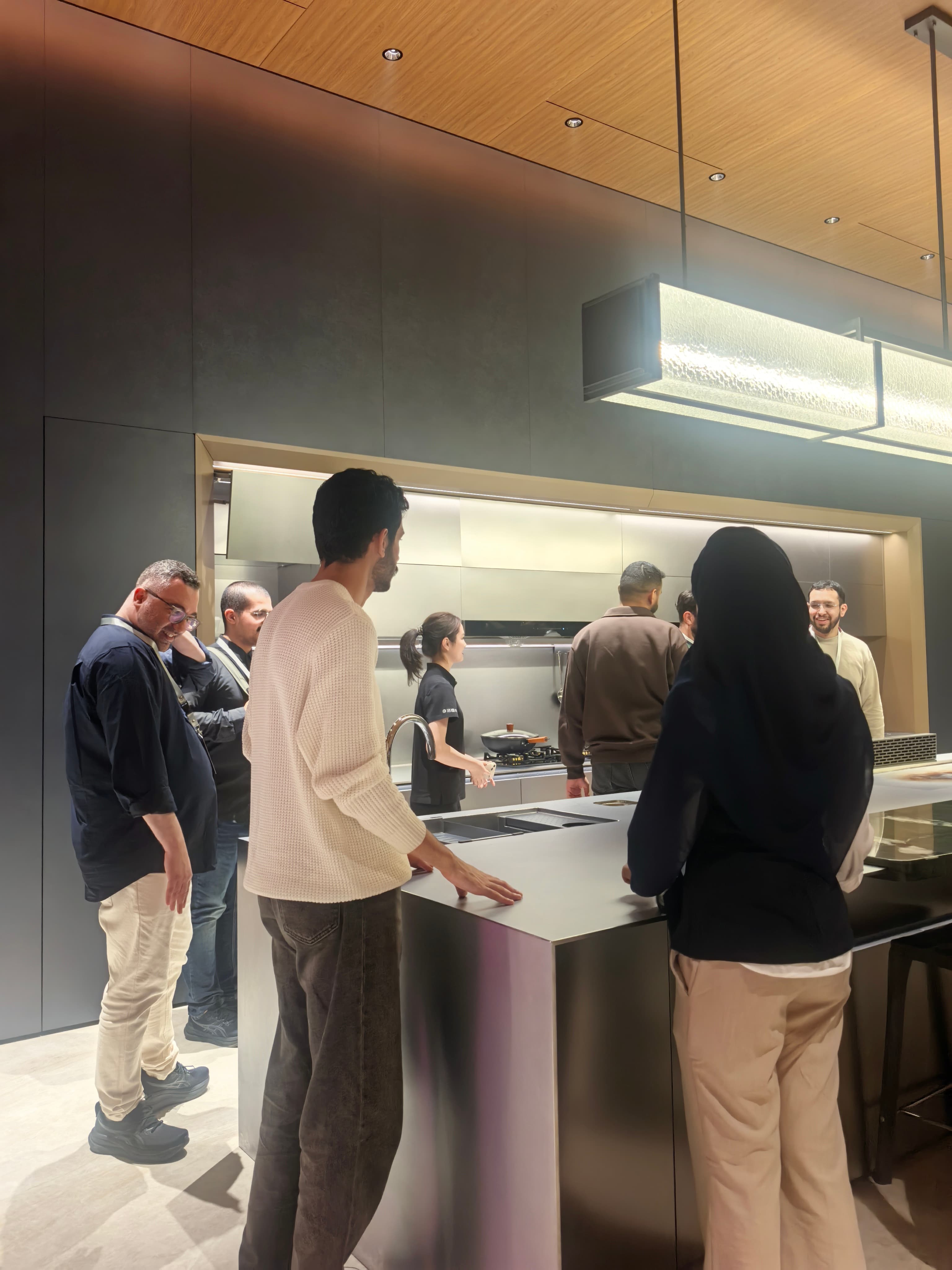 Trade visitors reviewing cabinetry details at close range