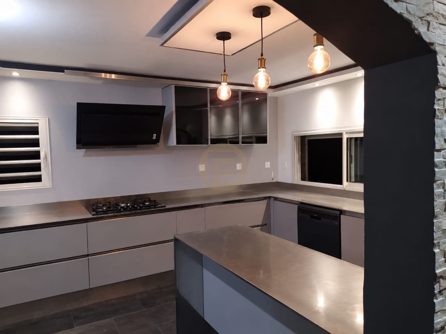 Blue island with linear lighting below the cabinet fronts