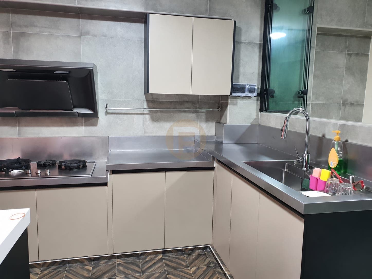 Compact Singapore kitchen with stainless steel worktops and a window-side sink