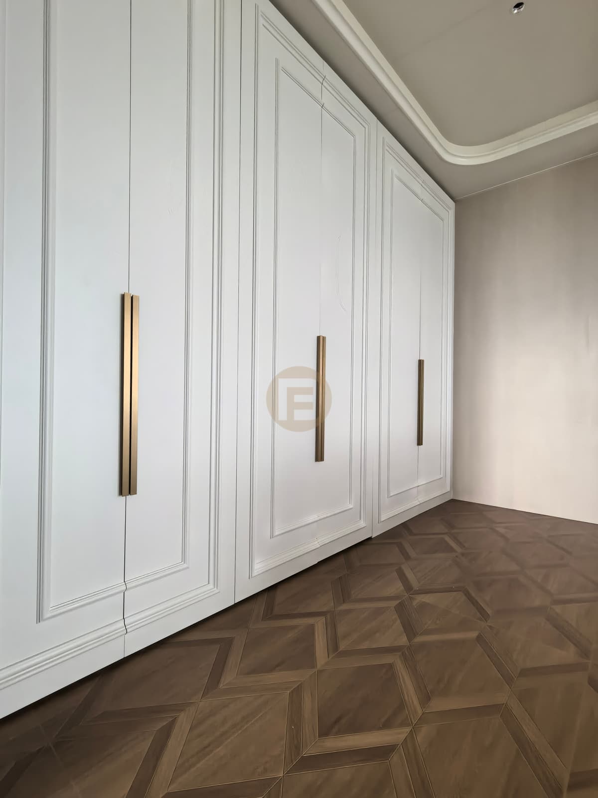 Detalle de armarios altos blancos para ropa con marco decorativo