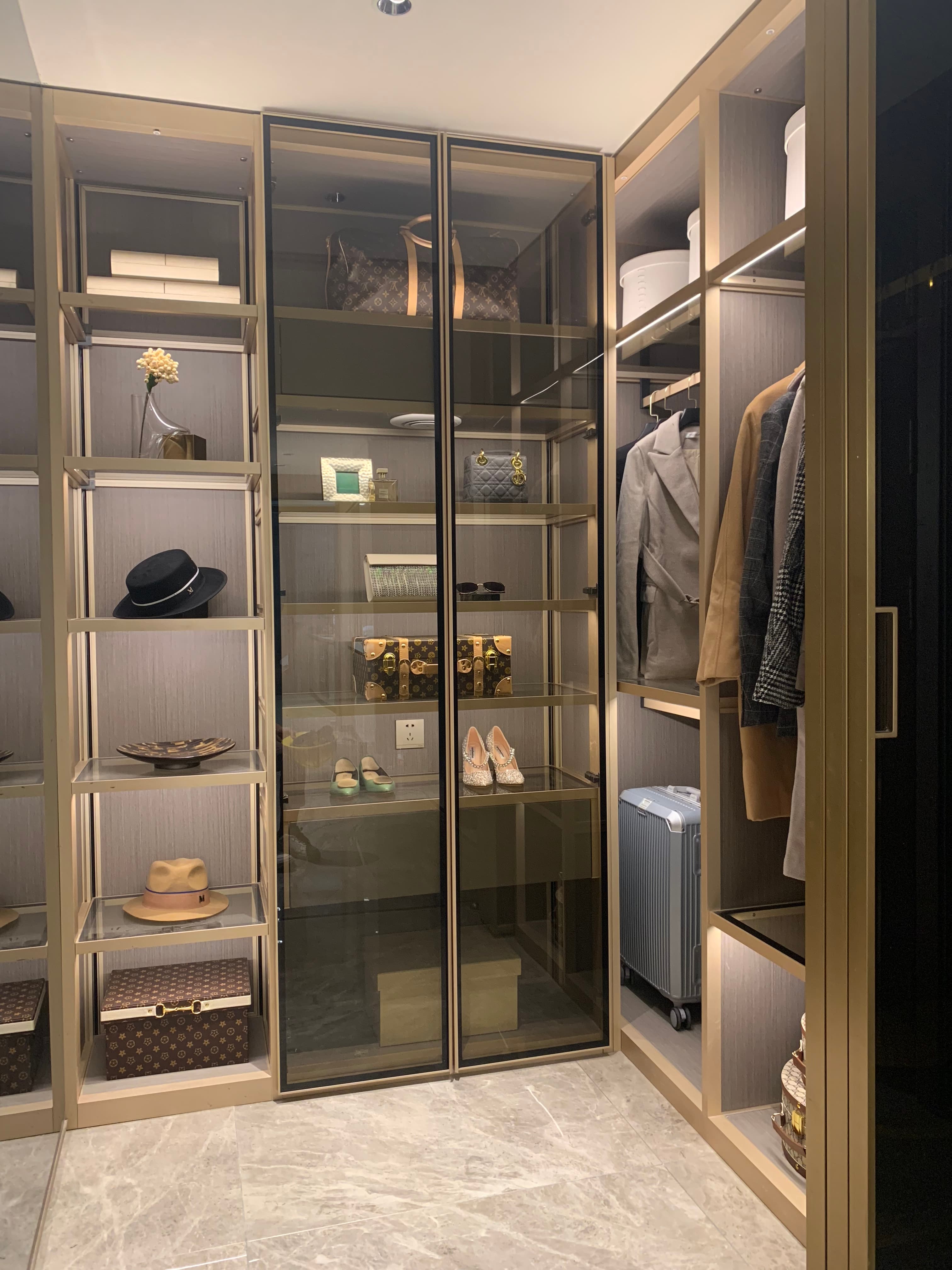 Illuminated glass-front dressing storage with shelves, hanging space and drawers