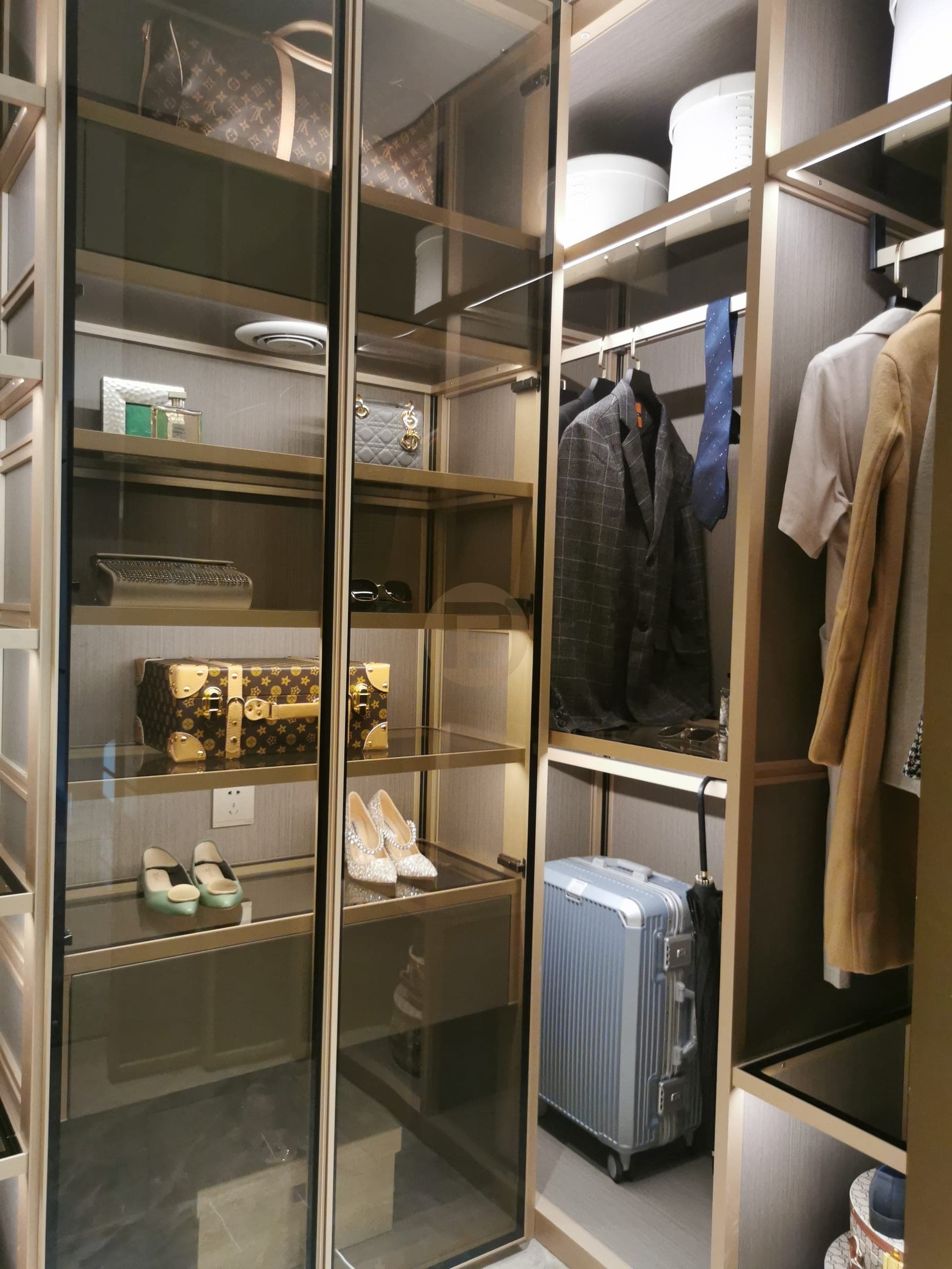 Side view of glazed dressing cabinet, display shelves and hanging rails