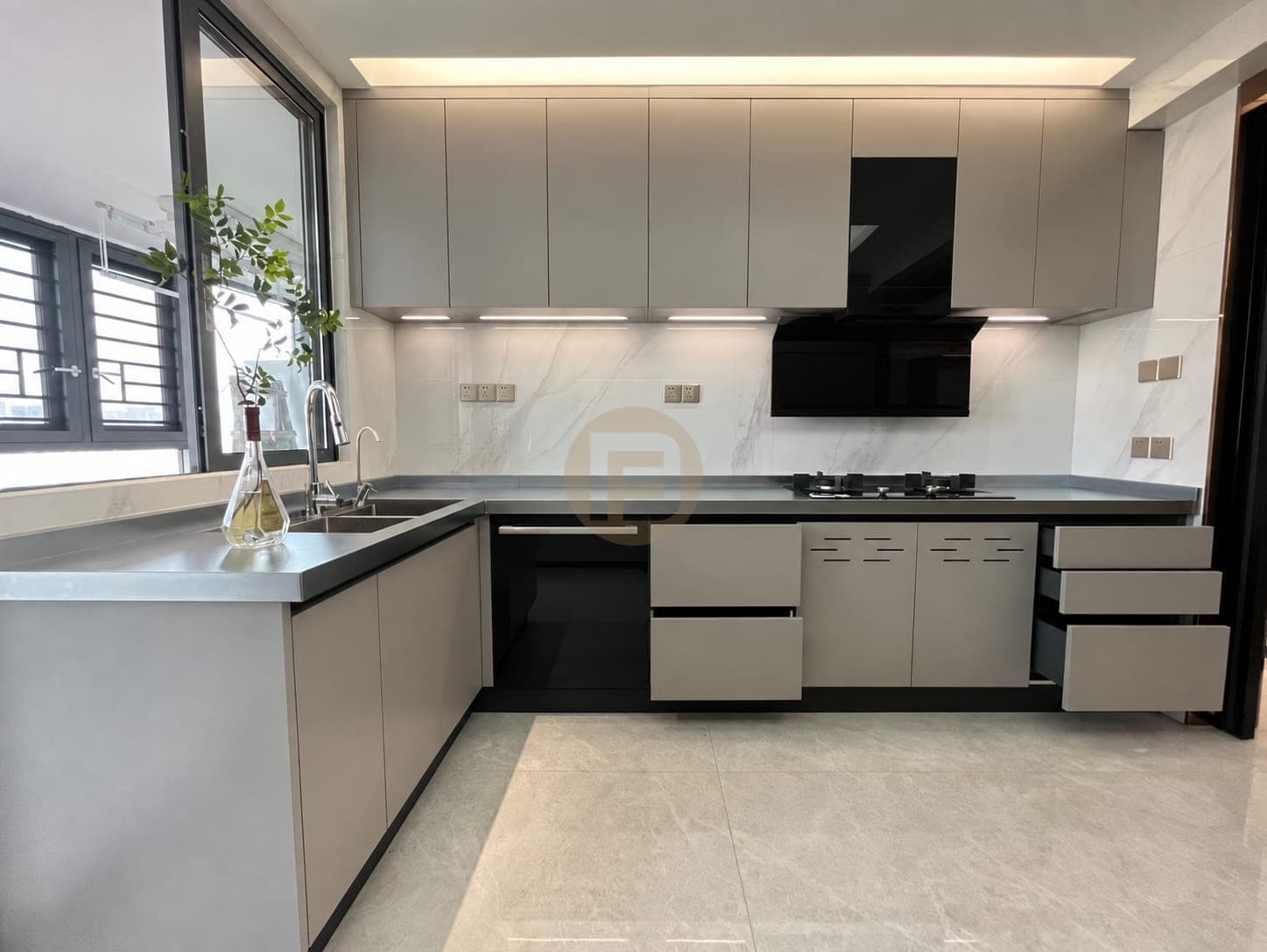 L-shaped kitchen with a window sink, stainless worktop and taupe cabinetry, drawers open