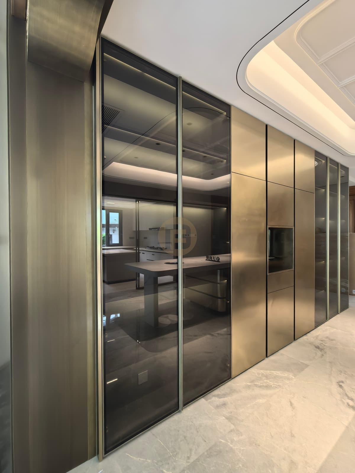 Metallic-tone cabinet wall with smoked glass sections