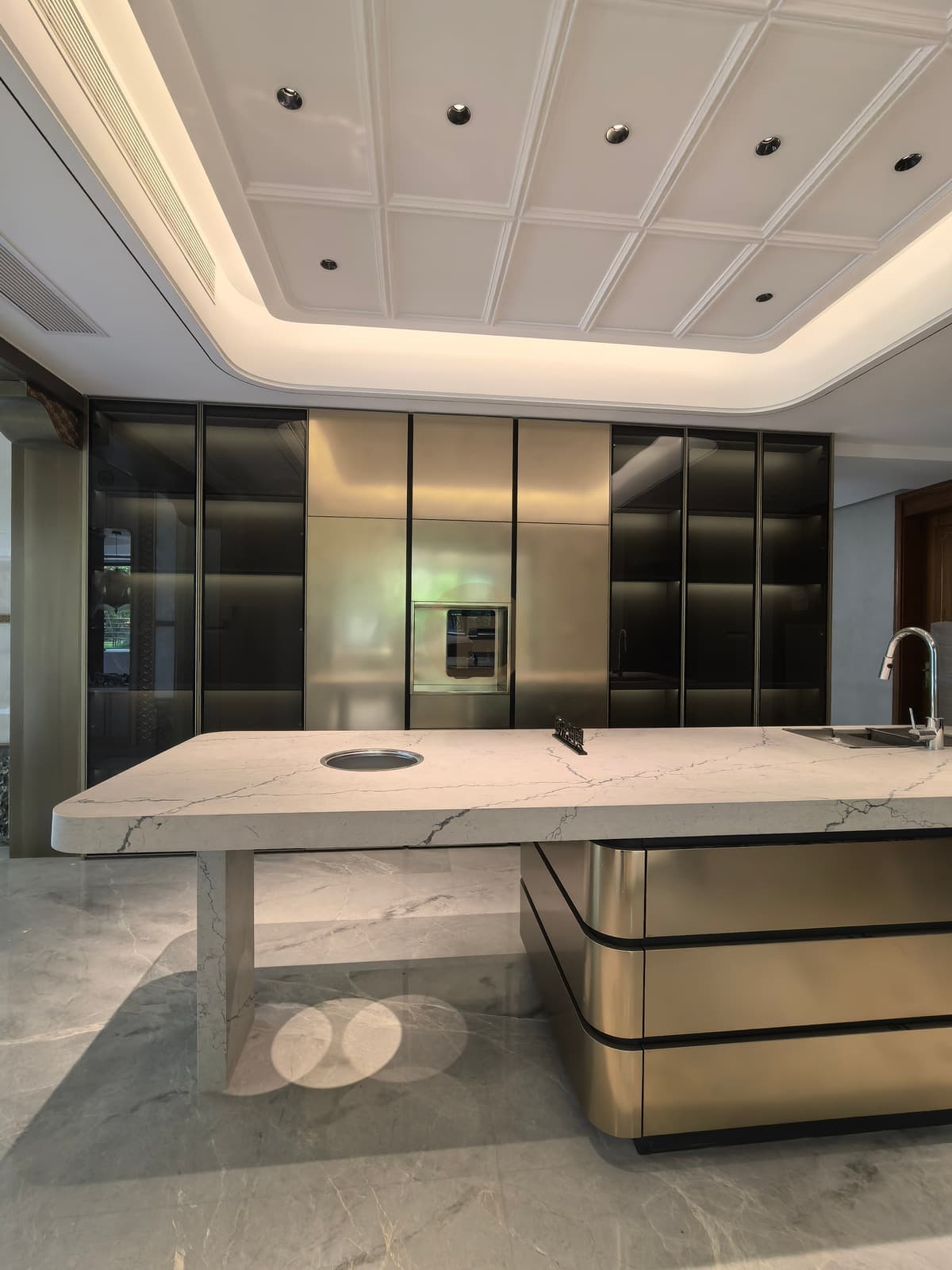 Metallic-tone kitchen island and full cabinet wall from the front
