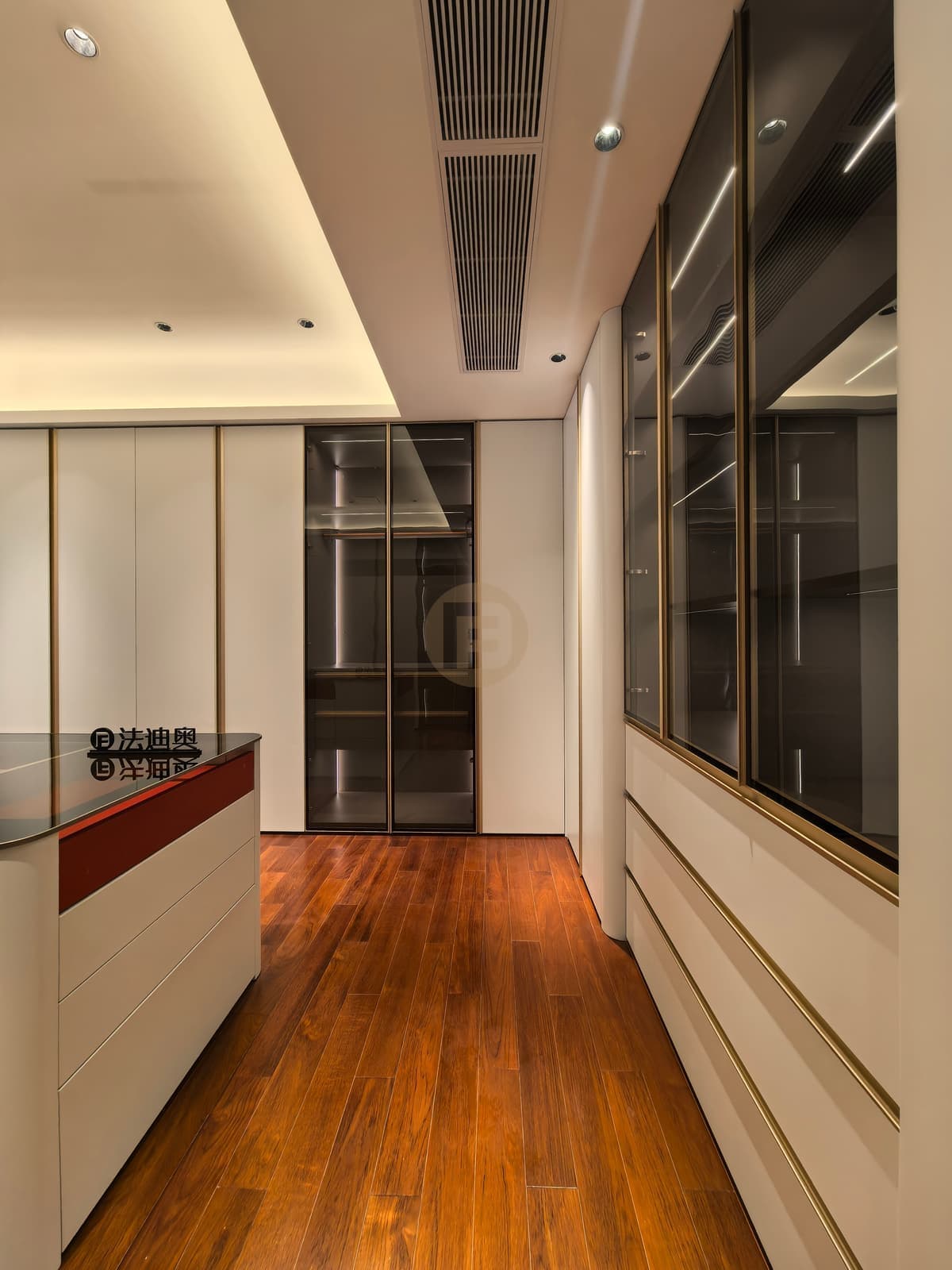White and glass clothing cabinets around a central island