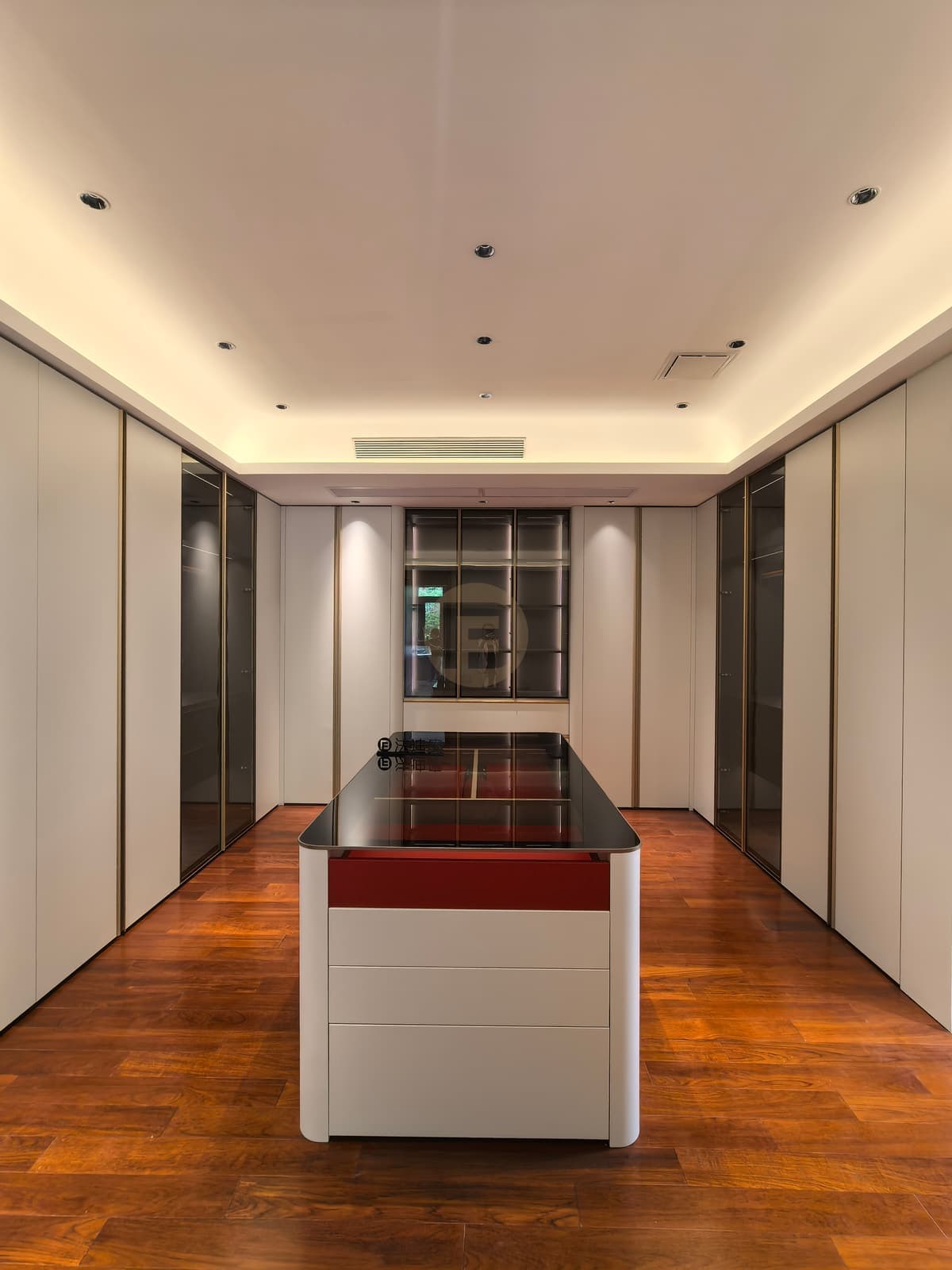 Clothing-storage suite with white cabinets and dark central island