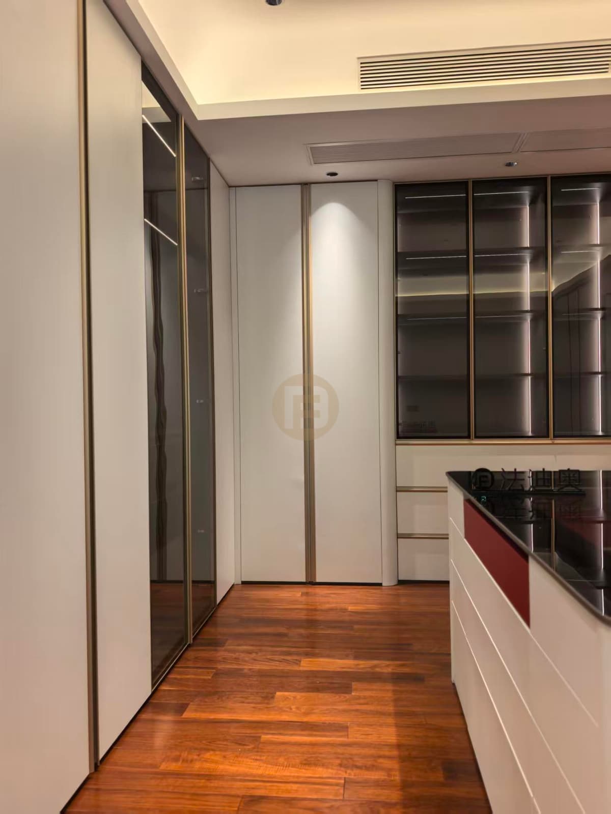 Tall glass clothing cabinets beside a central island