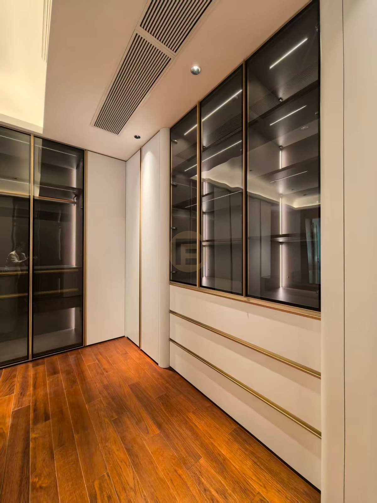 Glass and white fitted clothing cabinets with island