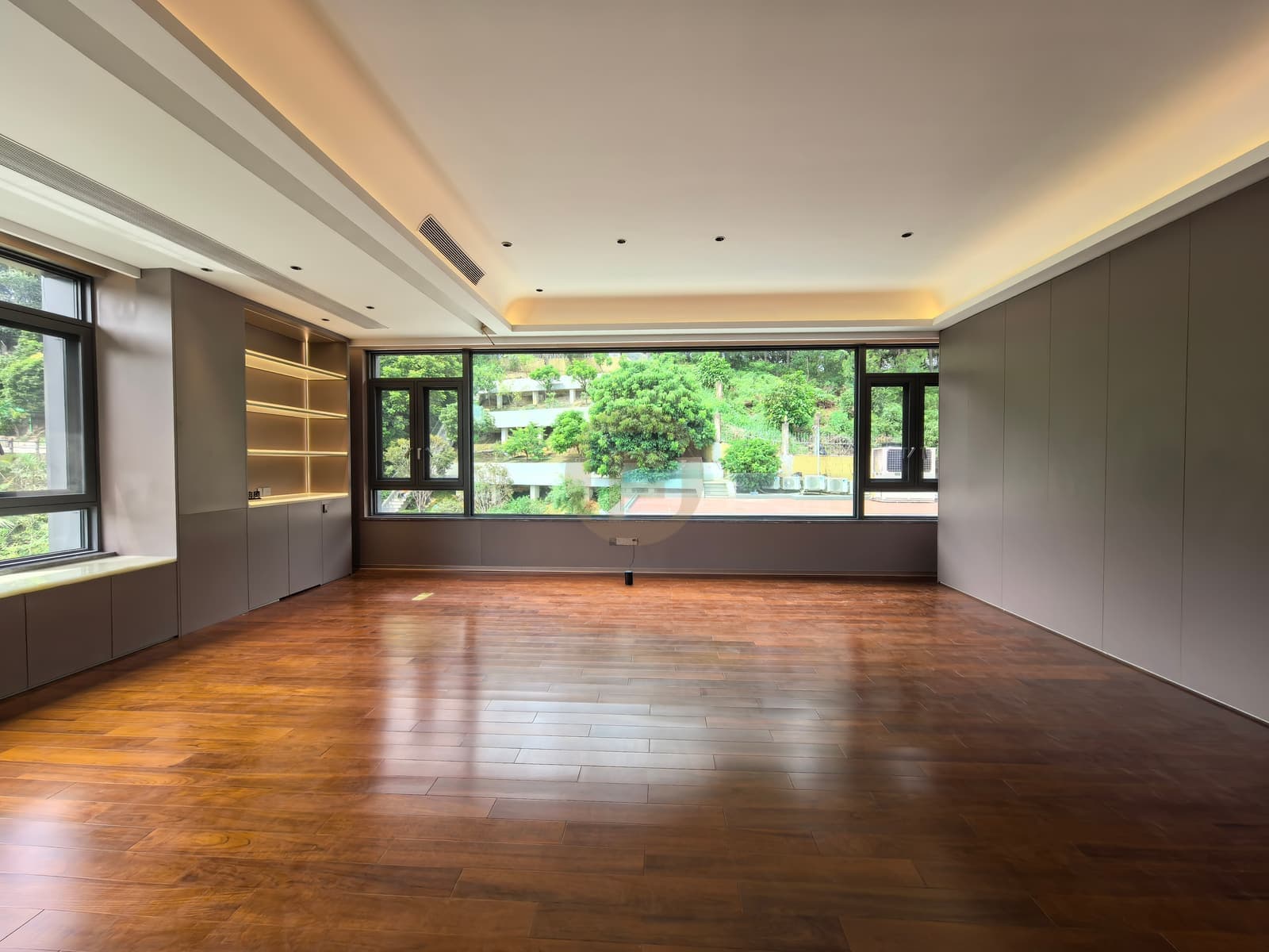 Wide room with grey cabinets and illuminated open shelving