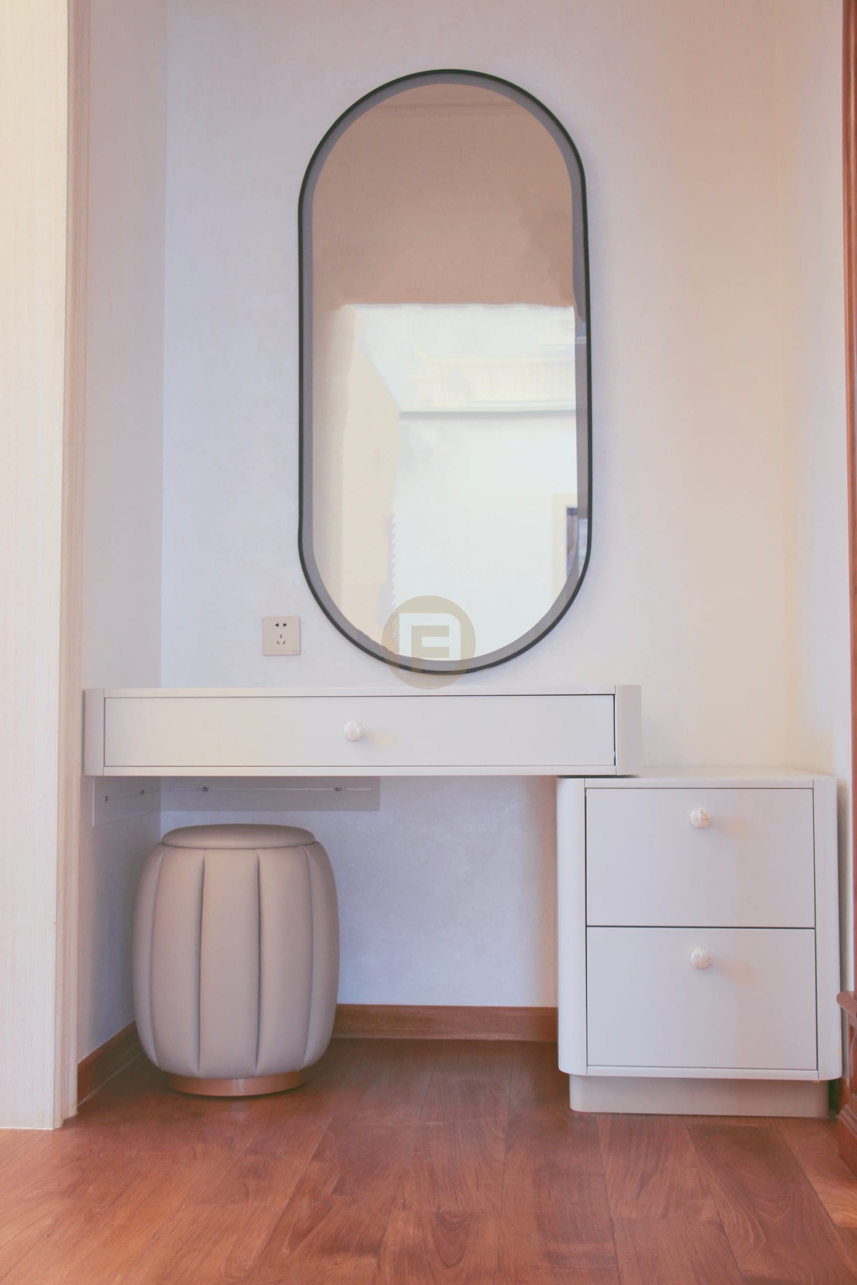White fitted dressing table with a drawer pedestal, pill-shaped mirror and stool