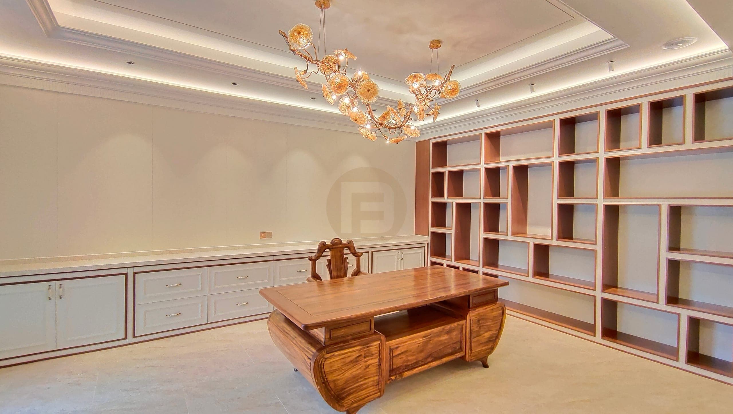 Study with a white base cabinet run, wood-and-white open shelving wall and carved wood desk