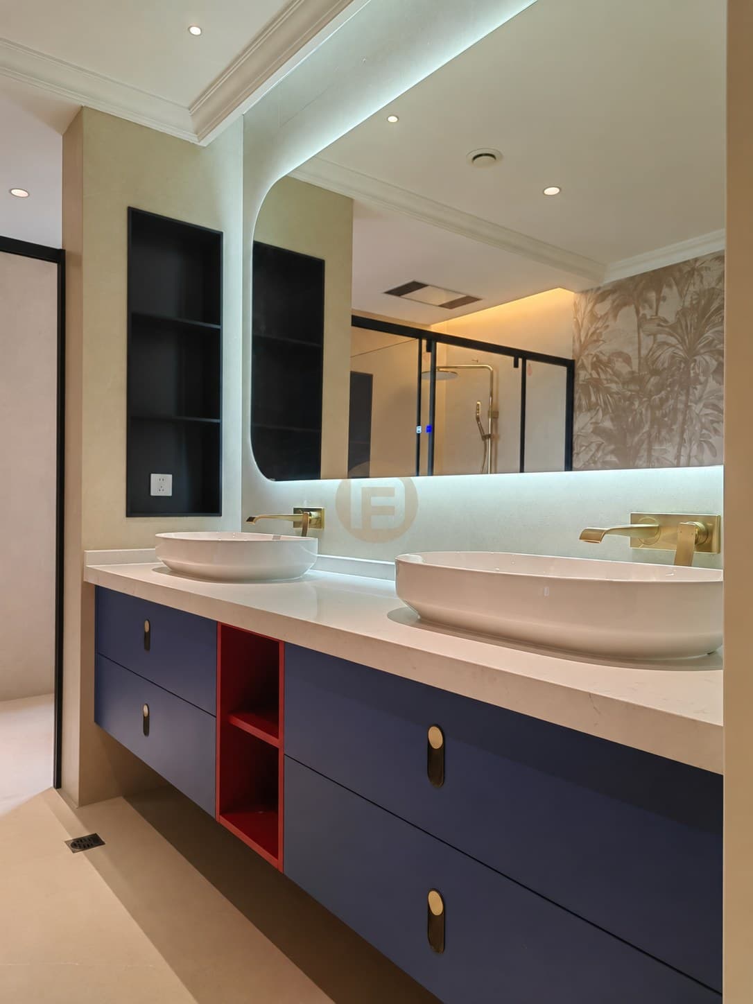 Navy floating double vanity with warm-toned metal taps and a backlit mirror