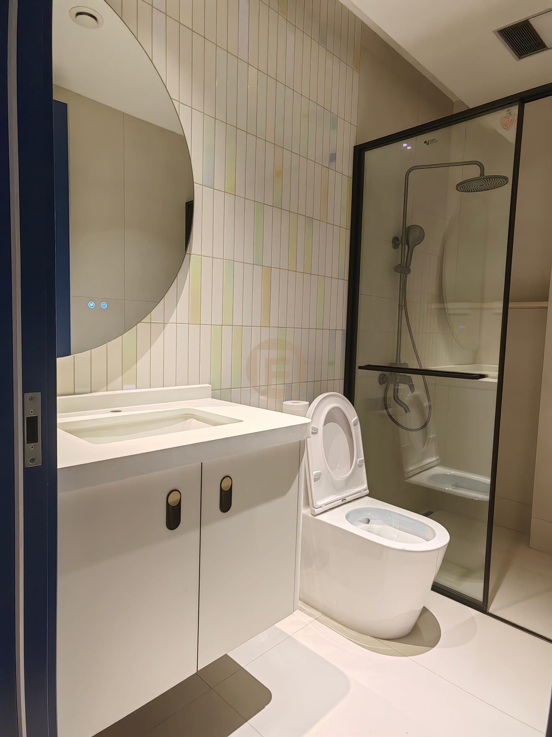 Compact powder-room vanity beside the toilet