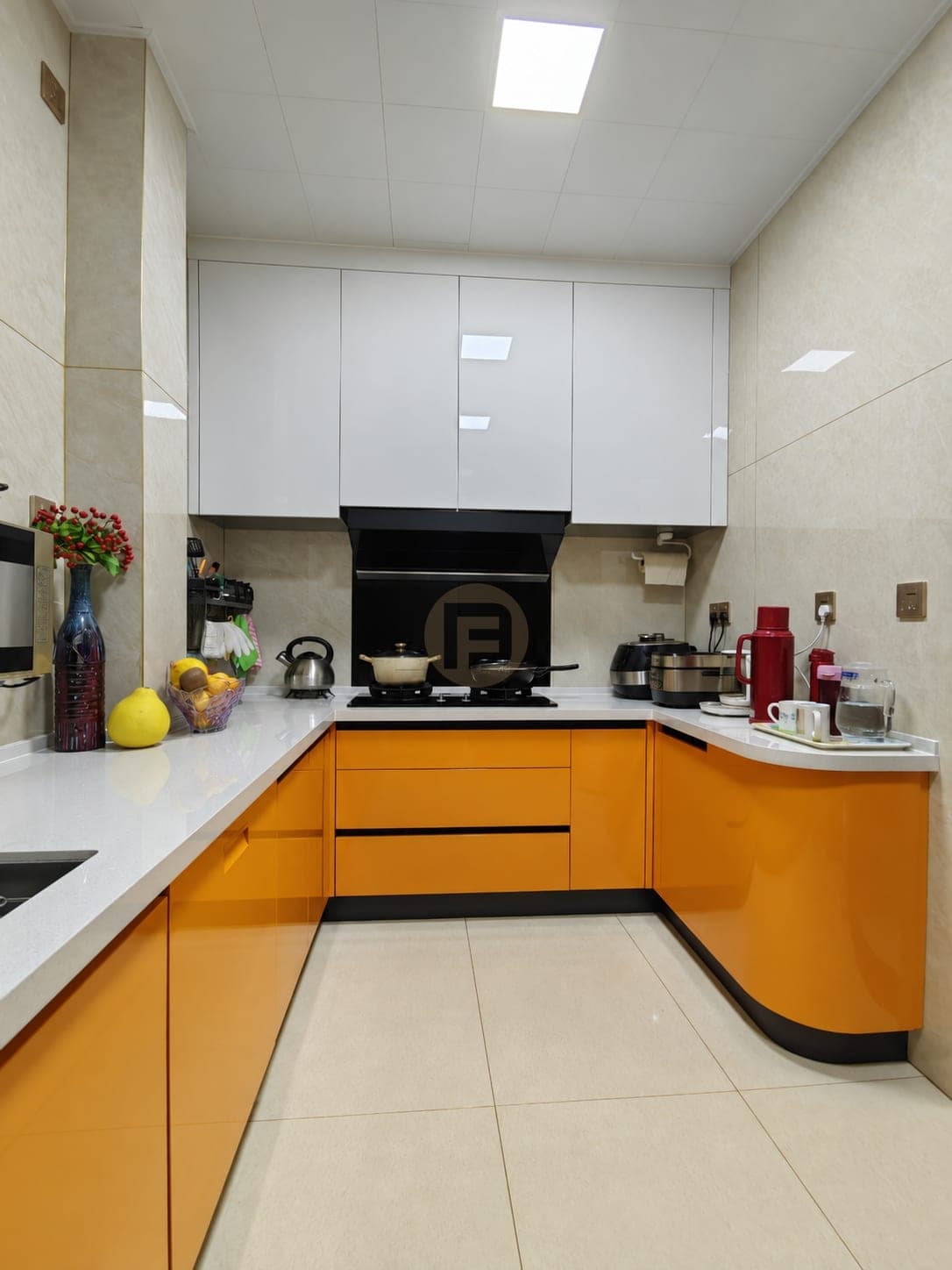 U-shaped kitchen with orange base cabinets, a curved end run and white gloss wall cabinets